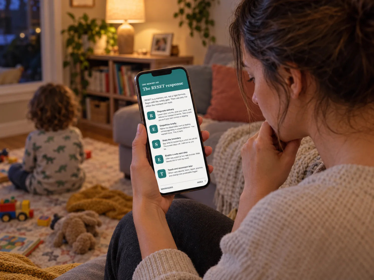 Parent checking the phone-friendly What to Say Next guide during a real family evening